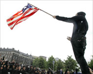 Protesters in Denmark set the US flag alight 