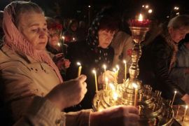 Ukrainians hold lit candles commemorating the 28th anniversary of the Chernobyl nuclear disaster in Kiev [AP]