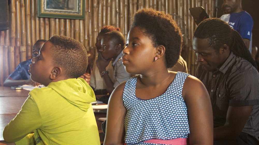 Children from Lagos watch spoken word poets perform at the 2015 War Of Words slam competition [Caelainn Hogan/Al Jazeera] 