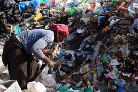 A woman separates plastic bottles at the Dandora landfill on the outskirts of Nairobi, Kenya [Al Jazeera: Courtesy of Pauline Mpungu]