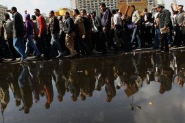 A crowd of anti-government protesters walk past a large puddle of water from tapped water mains in Tahrir Square on the morning of January 31, 2011 in central Cairo, Egypt [Chris Hondros/Getty Images]