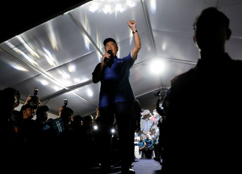 Muhyuddin Yassin, a former Malaysian prime minister, raises his arm as he speaks at a nighttime rally in Kuala Lumpur, Malaysia.
