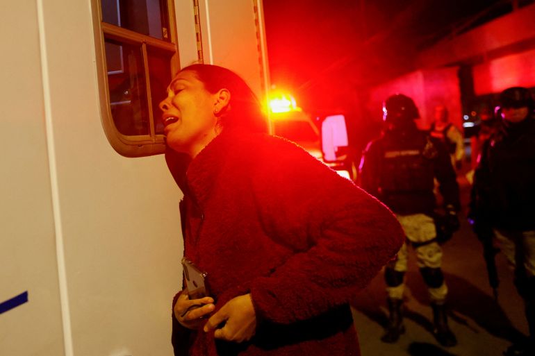 Viangly, a Venezuelan migrant, reacts outside an ambulance for her injured husband Eduard Caraballo while Mexican authorities and firefighters remove injured migrants, mostly Venezuelans, from inside the National Migration Institute (INM) building during a fire, in Ciudad Juarez, Mexico March 27, 2023