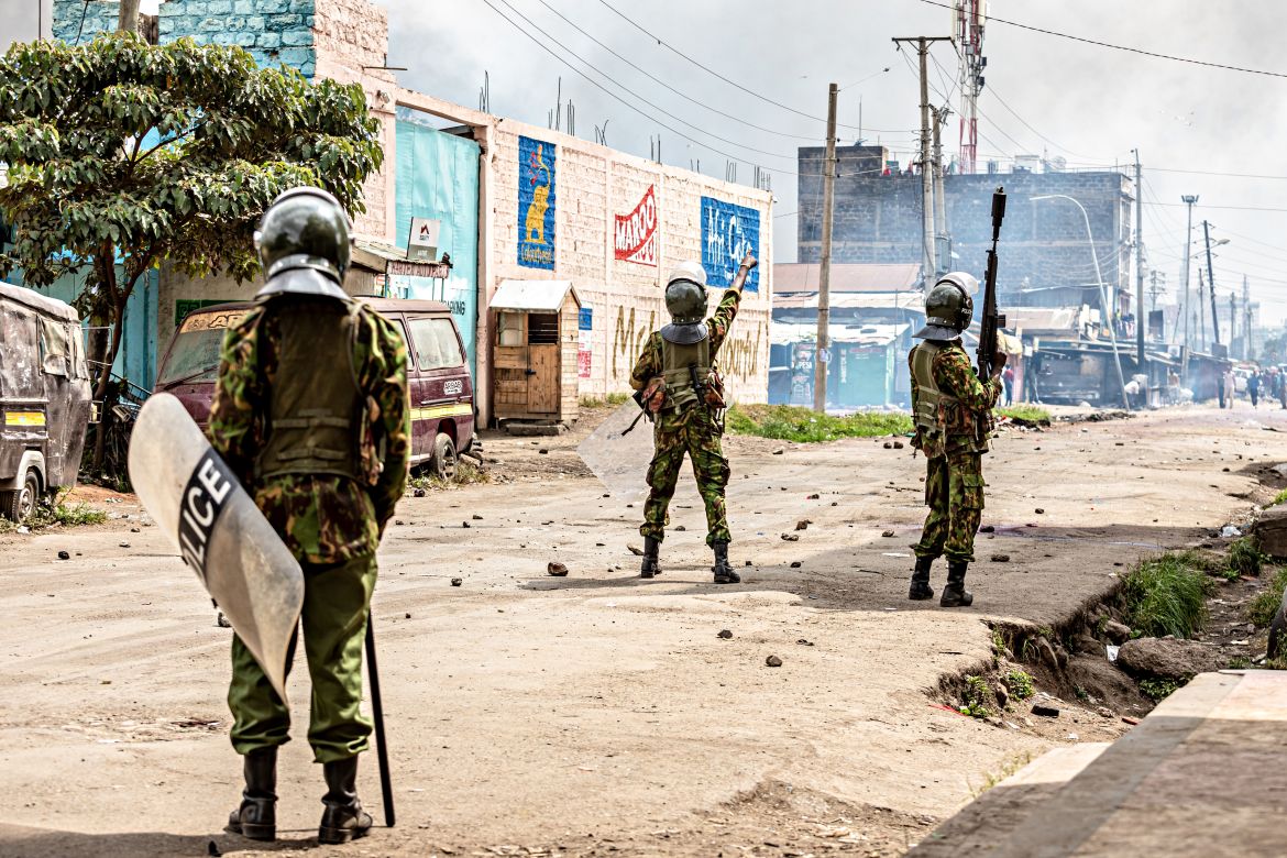 Anti-riot police officers stand in a street after dispersing anti-government protesters at Shauri Moyo, Nairobi.