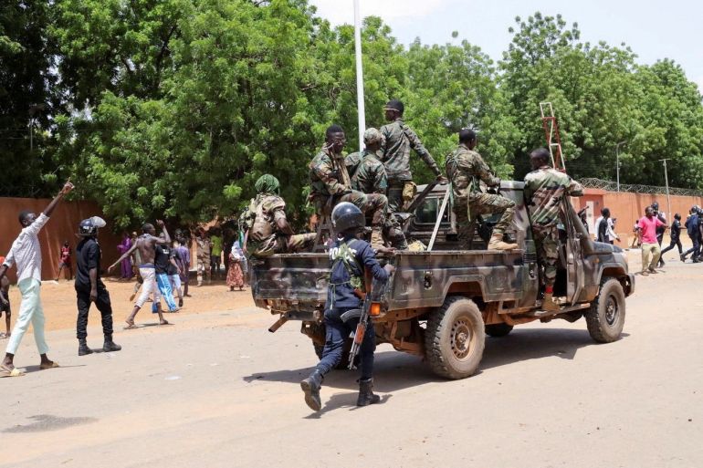 Nigerien security forces prepare to disperse pro-coup demonstrators gathered outside the French embassy, in Niamey