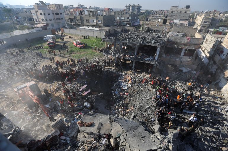 Palestinians search for causalities at the site of an Israeli strike on a house