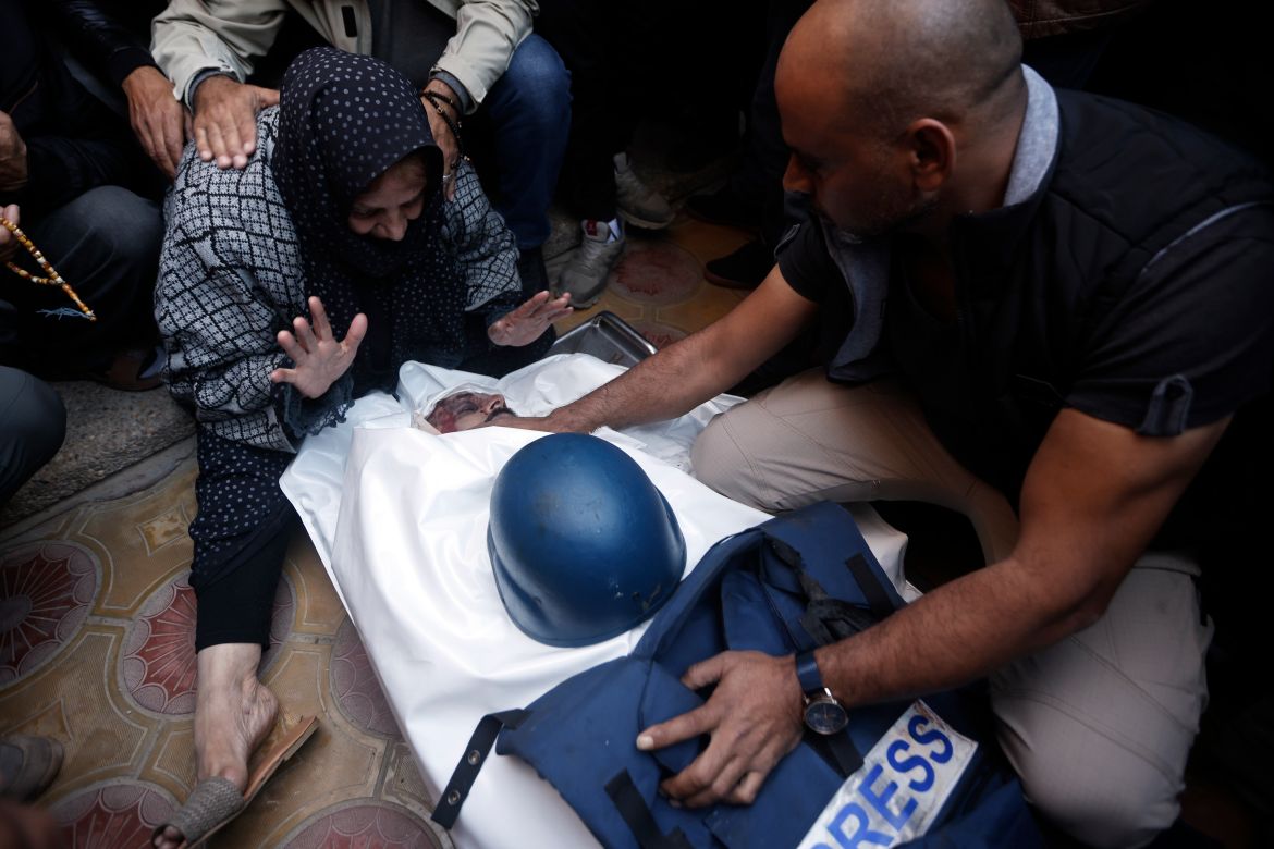 Relatives of the Al Jazeera cameraman, Samer Abu Daqqa, who was killed by anIsraeli airstrike, mourn over his body, during his funeral in the town of Khan Younis, southern Gaza Strip. Saturday, Dec. 16