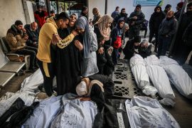 Palestinians mourn after identifying corpses of relatives killed in overnight Israeli bombardment on the southern Gaza Strip