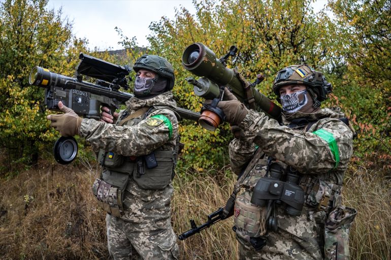 Two Ukrainian soldiers check the scopes of their anti-aircraft systems to ensure they're working properly before heading out on a mission in Donetsk Oblast, Ukraine on October 19, 2024. The Ukrainian military relies on small, mobile units to defend and protect the skies as warfare evolves, with the proliferation of drones and Russian air superiority. Photojournalist:Fermin Torrano