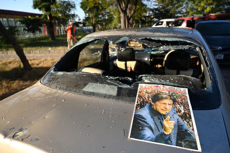 A poster of jailed former Pakistan's prime minister Imran Khan is pictured on a damaged vehicle after an overnight security forces operation against the supporters of Khan's Pakistan Tehreek-e-Insaf (PTI) party in Islamabad on November 27, 2024. - Protesters who marched on the Pakistan capital to demand the release of jailed former prime minister Imran Khan were cleared from the city centre on November 27 after a sweeping security crackdown. (Photo by Aamir QURESHI / AFP)