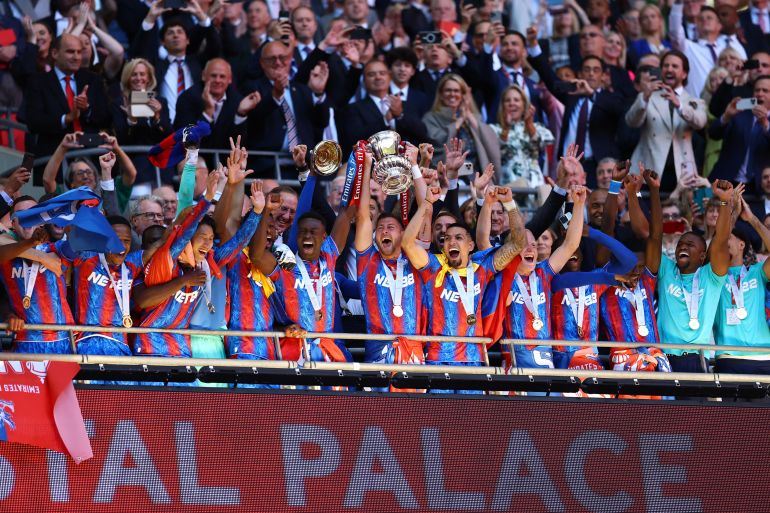 Crystal Palace's Marc Guehi and Joel Ward lift the trophy as they celebrate with teammates after winning the FA Cup