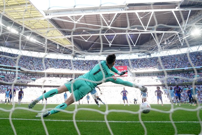 Crystal Palace goalkeeper Dean Henderson saves Manchester City's Omar Marmoush's penalty kick
