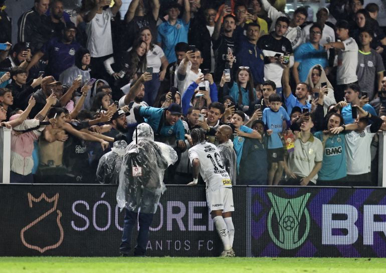 Santos' Neymar is seen with fans after the match