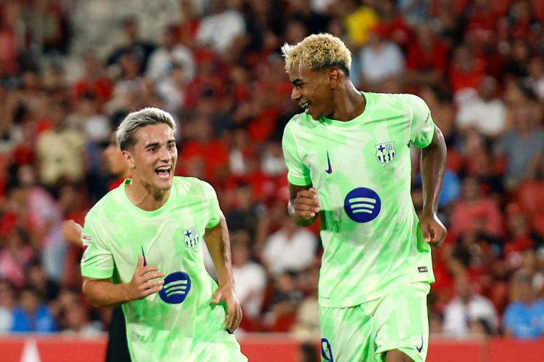 Barcelona's Lamine Yamal celebrates scoring their third goal with Gavi