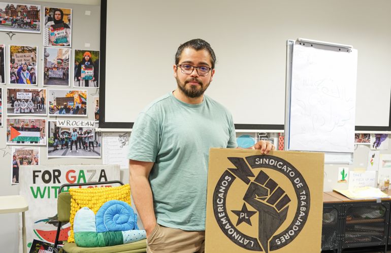Freddy Abadia with the logo of the Latin American Workers’ Union he has established with the help of local organisations-1759249270