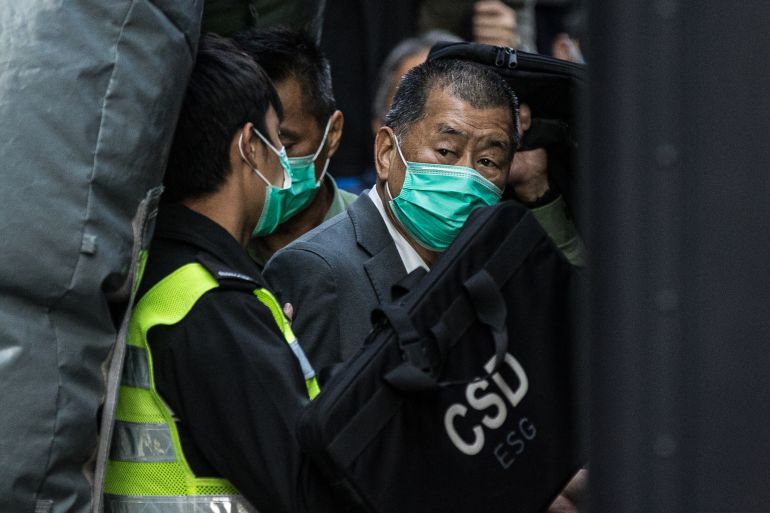 Media tycoon Jimmy Lai (R) is escorted into a Hong Kong Correctional Services van outside the Court of Final Appeal in Hong Kong on February 1, 2021, after being ordered to remain in jail while judges consider his fresh bail application, the first major legal challenge to a sweeping national security law Beijing imposed on the city last year. (Photo by AFP)