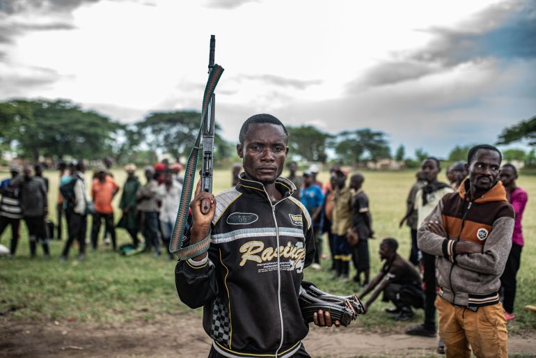 UVIRA, DEMOCRATIC REPUBLIC OF CONGO - DECEMBER 15: A Wazalendo militant surrenders a weapon to members of the Rwanda-backed M23 rebel group on December 15, 2025 in Uvira, Democratic Republic of Congo. Fifty-two members from the coalition of Congolese and Burundian militias known as the Wazalendo joined M23 following the rebels' capture of the South Kivu city on December 10. Human Rights Watch has reported abuses perpetrated against civilians by fighters from both sides of the conflict during the offensive on Uvira, and has called for the safe passage and humanitarian assistance for those caught up in the fighting. (Photo by Daniel Buuma/Getty Images)