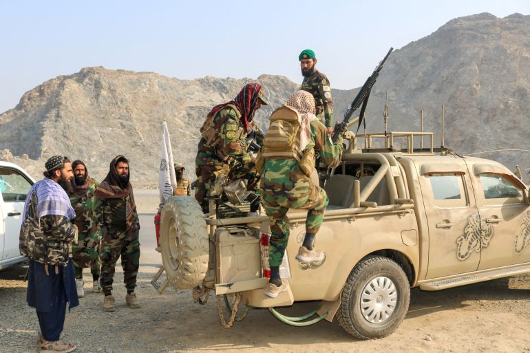 Taliban soldiers carry rocket launcher in a vehicle near Torkham border