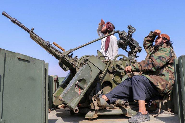 Taliban soldiers sit next to an anti-aircraft gun while on lookout for Pakistan's fighter jets, in Khost province, Afghanistan, February 27, 2026. REUTERS/Stringer TPX IMAGES OF THE DAY