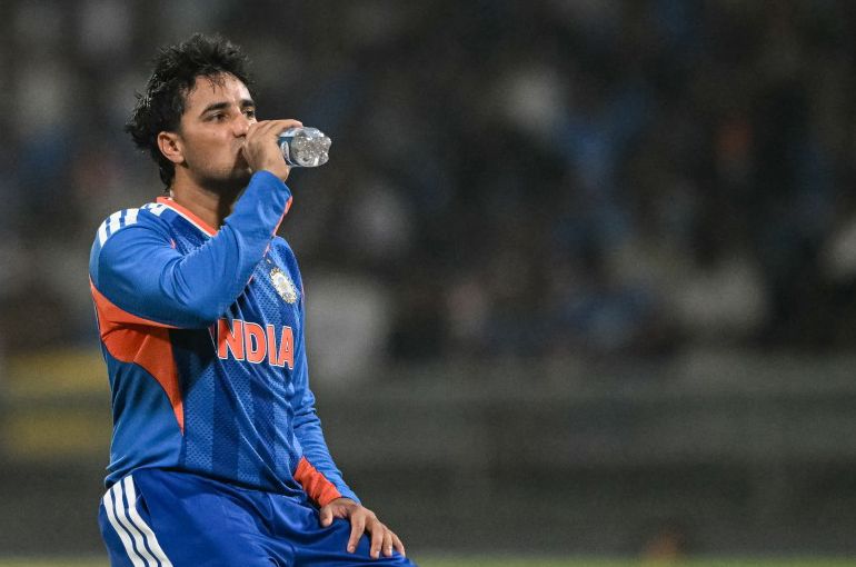 India's Abhishek Sharma drinks water during a break on the field.