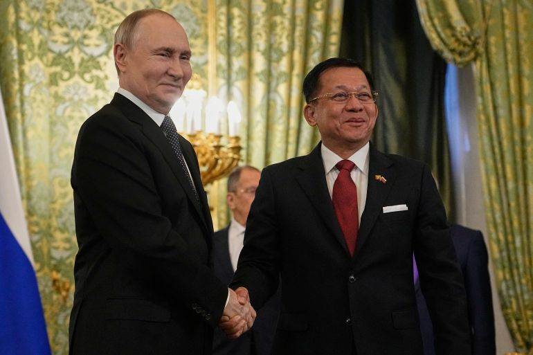 Russian President Vladimir Putin shakes hands with Myanmar's military chief Min Aung Hlaing
