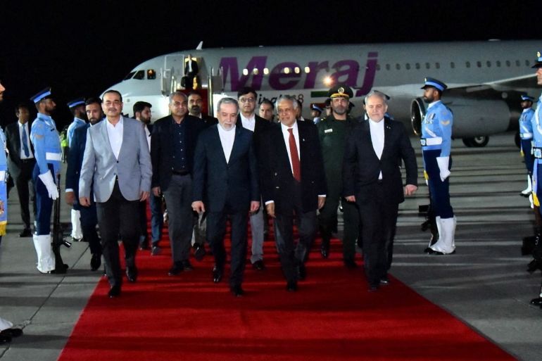 Iranian Foreign Minister Abbas Araqchi walks with Pakistan's Foreign Minister Mohammad Ishaq Dar and Army Chief