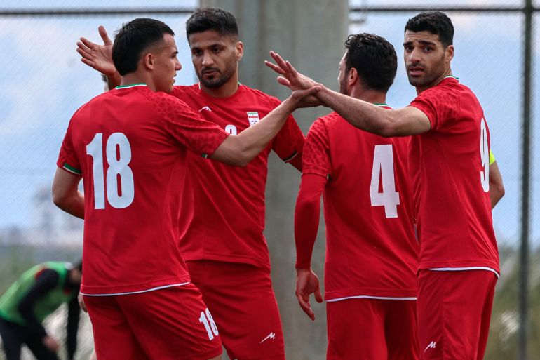 Iran's forward #18 Amirhossein Hosseinzadeh celebrates with his teammates after scoring a goal during a friendly football match between Iran and Costa Rica, in Antalya, southern Turkey, on March 31, 2026. FIFA's president told AFP that Iran "will be at the World Cup" despite the Middle East war. (Photo by Adem ALTAN / AFP)